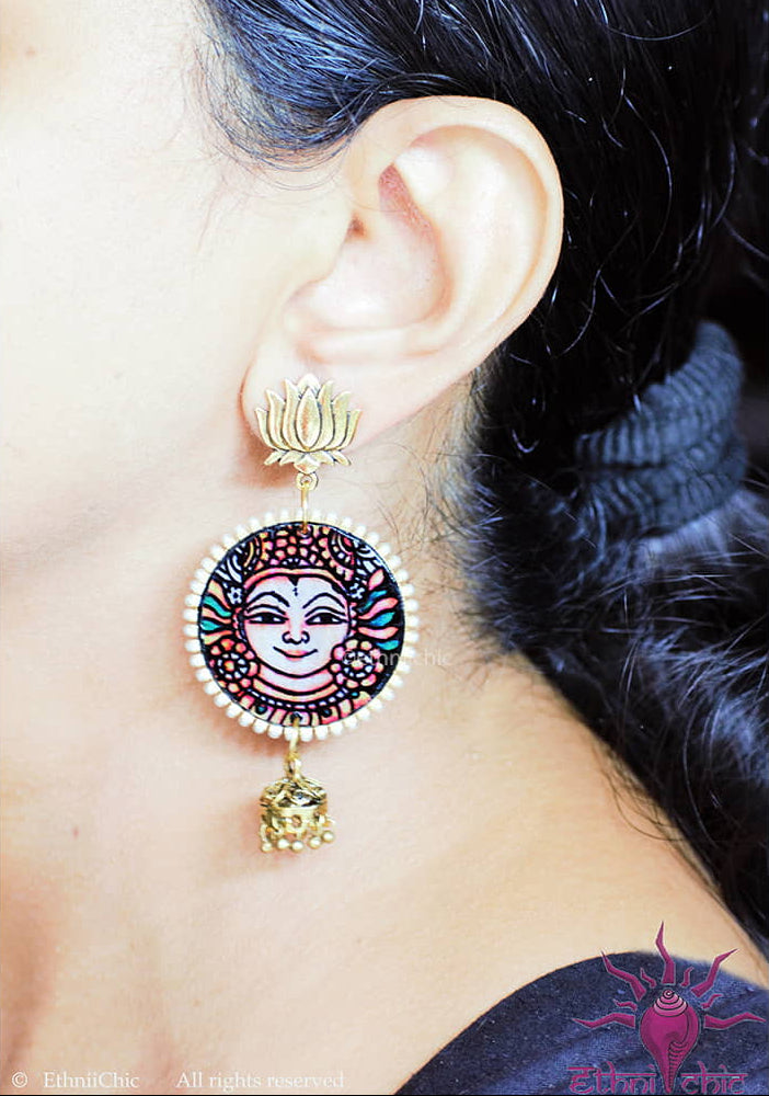 Mock-up of a woman wearing the Kerala Mural Hand-Painted Earrings – Apsara