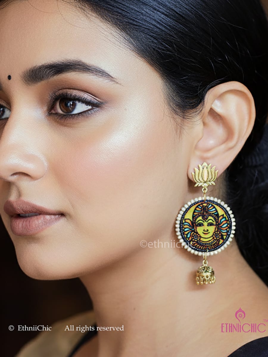Close-up of a woman wearing the decorative Kerala Mural Hand-Painted danglers with Yellow Mural Yellow